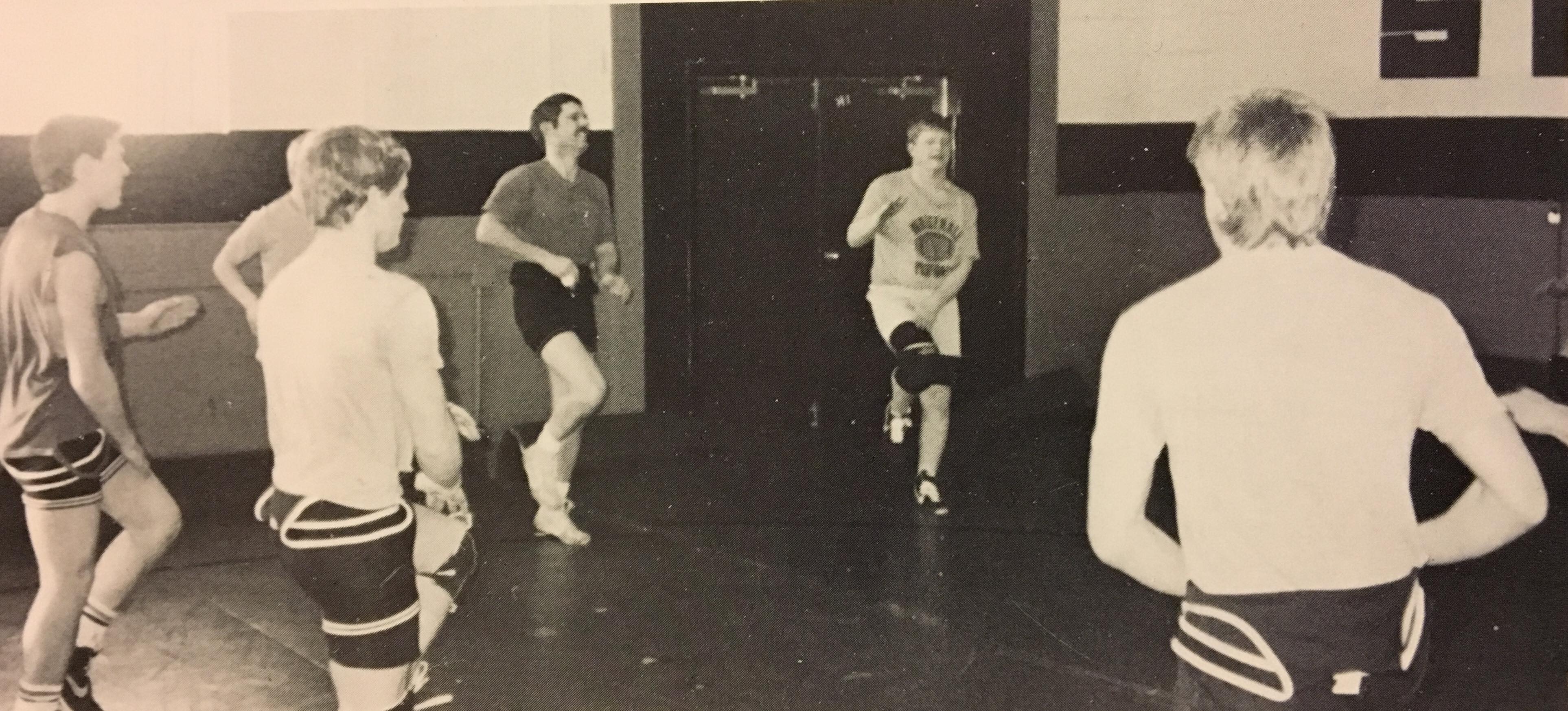 Jim Powell, Jerry Leque, Coach Hauser, Craig Thompson, and Clark Kulig warm up for practice.