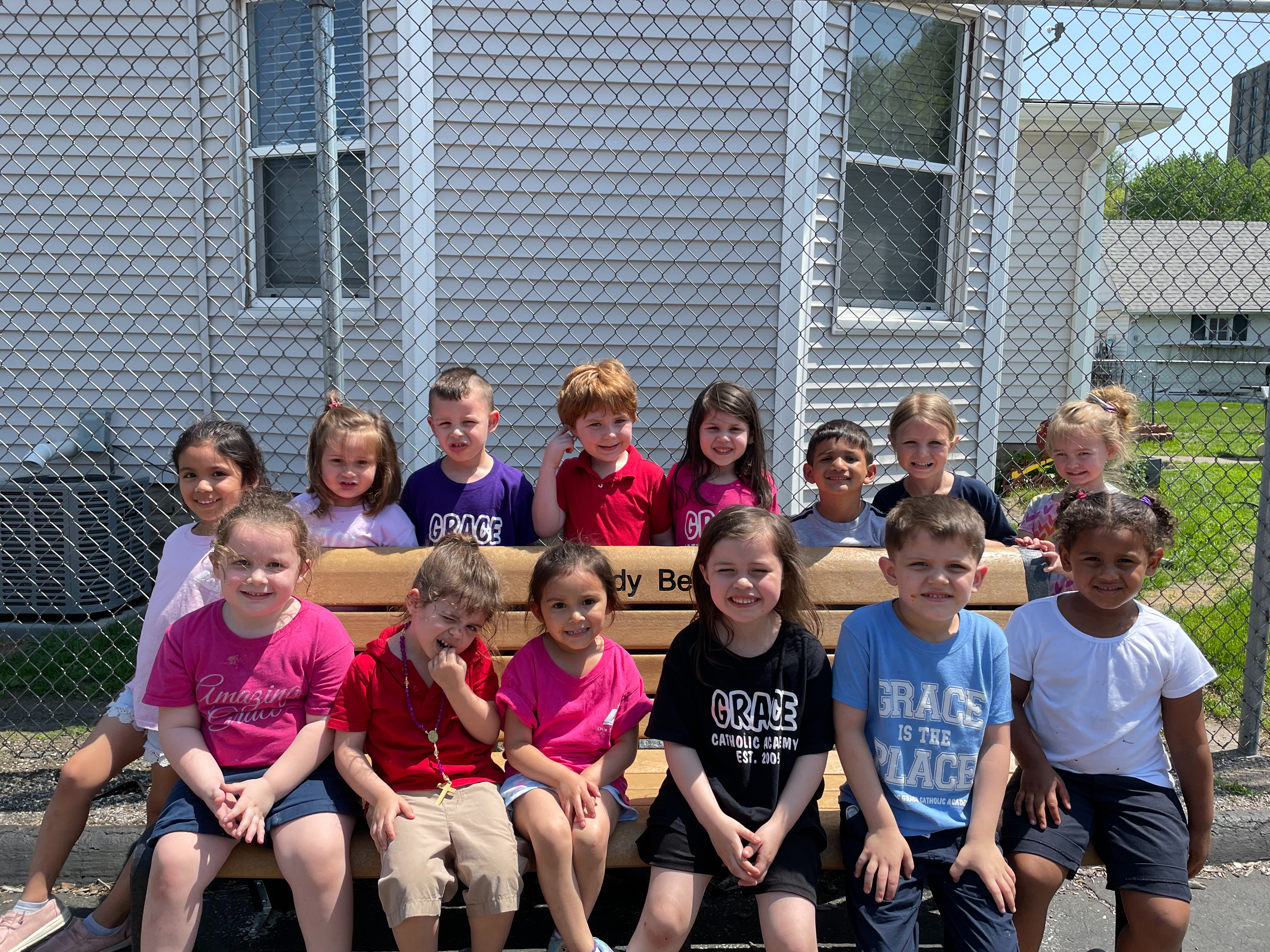 Preschool students sitting on our buddy bench