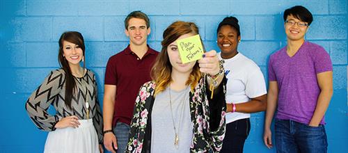 xello students infront of a blue wall with sticky note