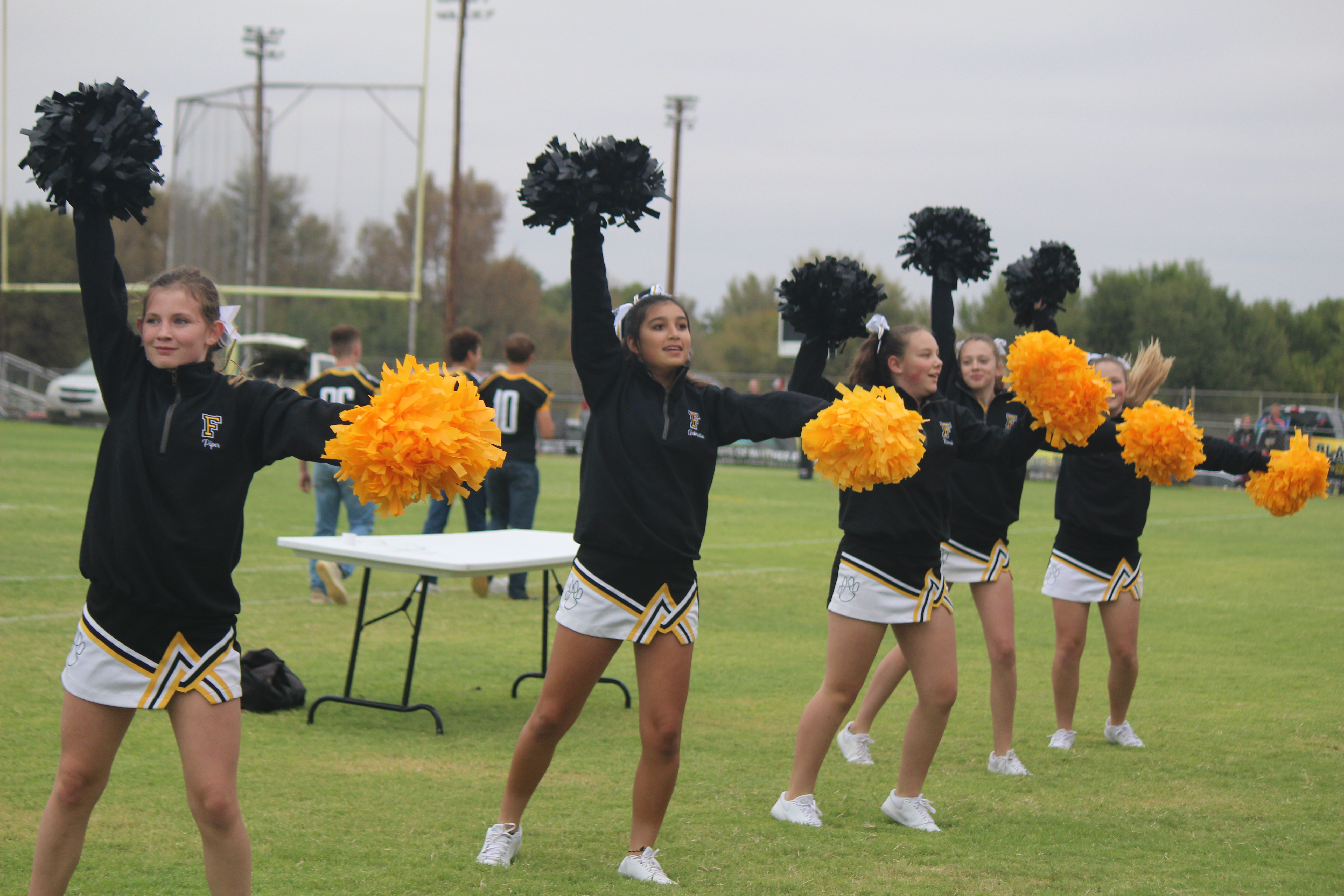 Junior high cheer performing the fight song