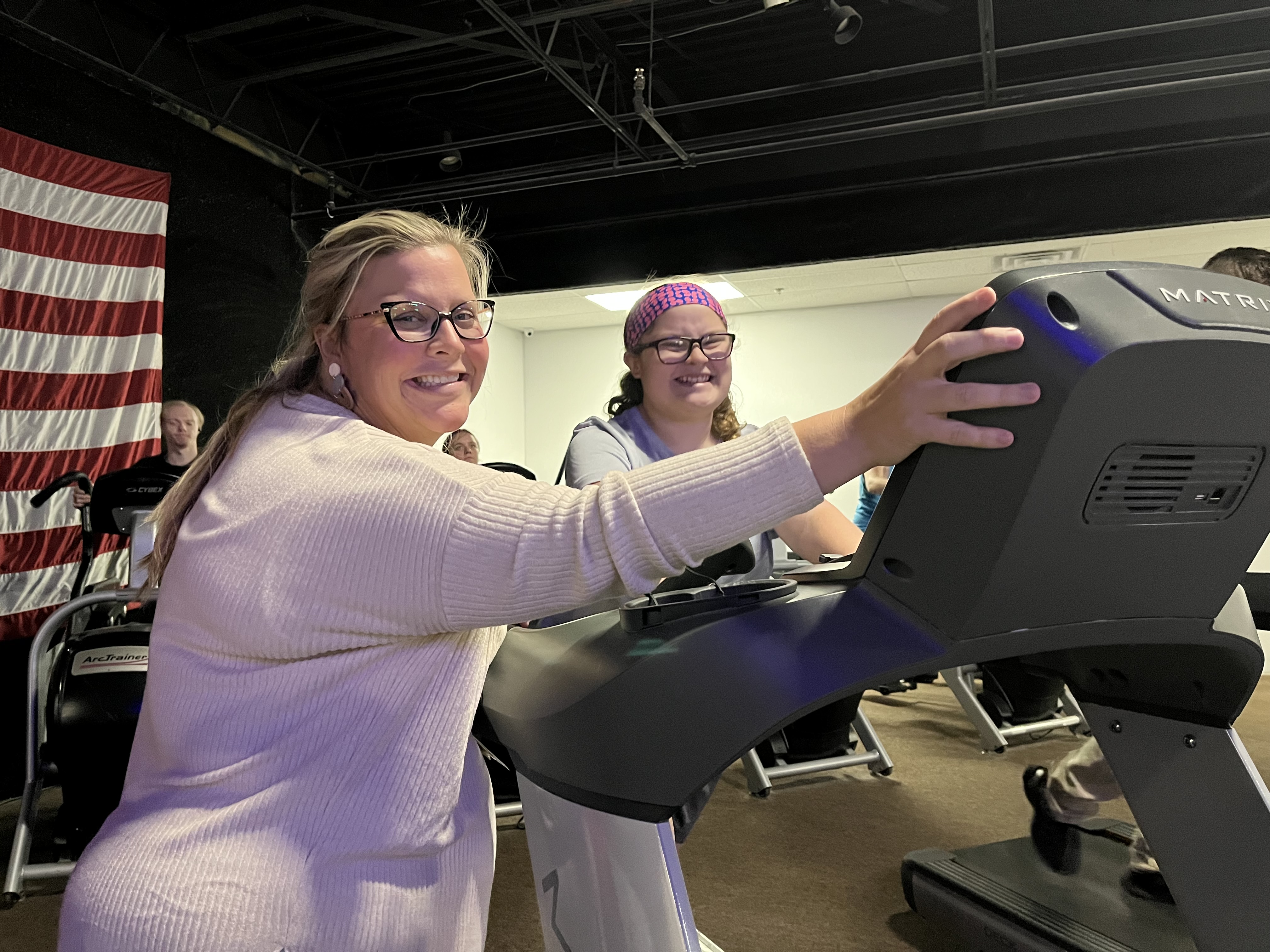 Teacher helping student on treadmill
