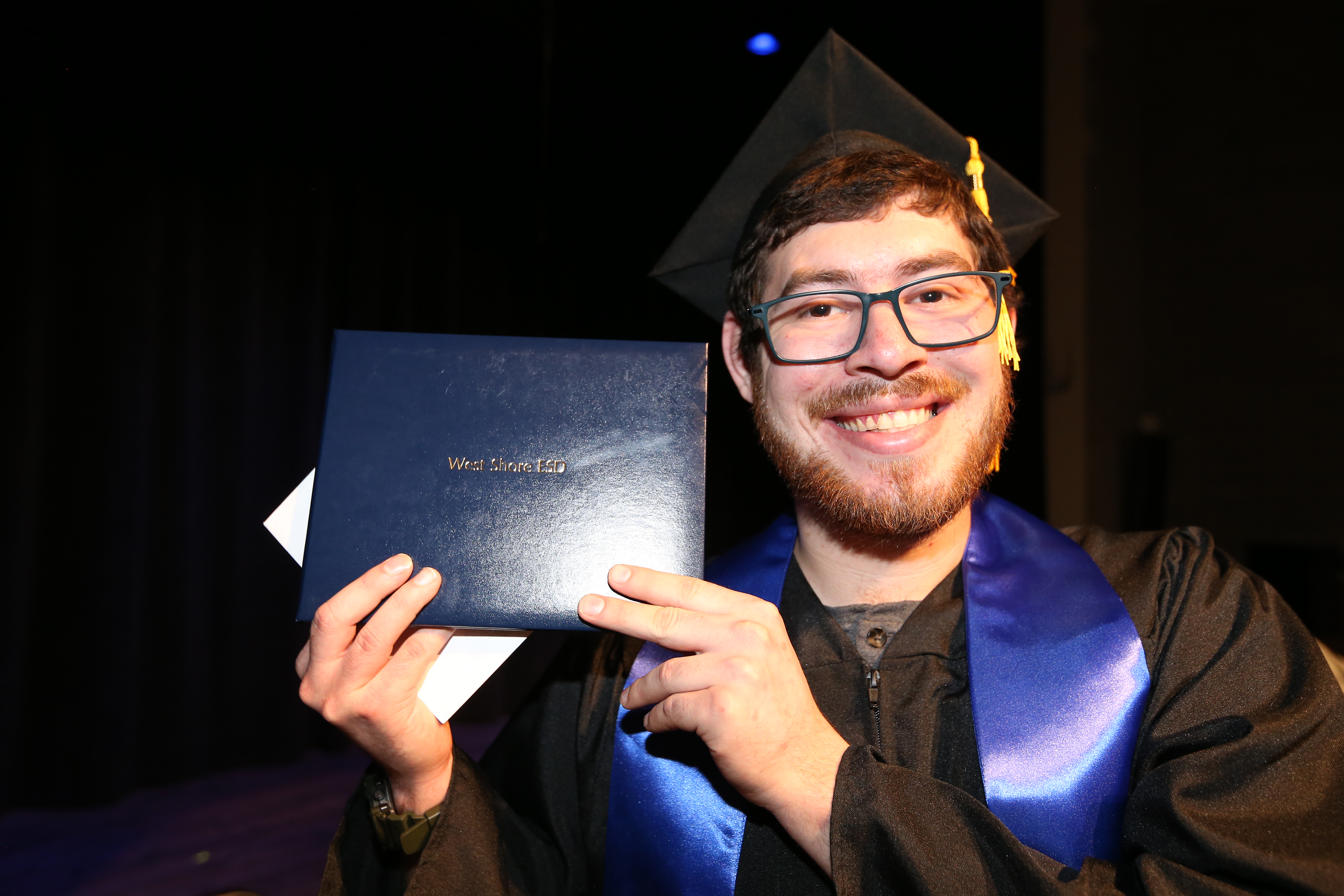 Student holding their diploma 