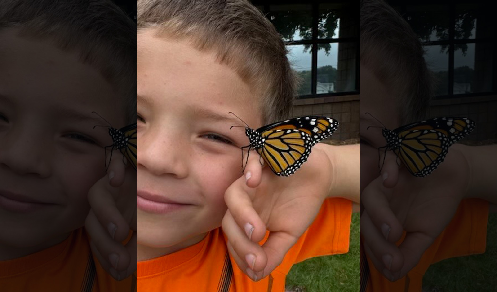 Student holding butterfly