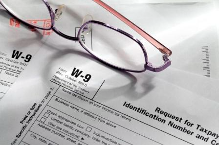 A pair of glasses on top of a W-9 Form