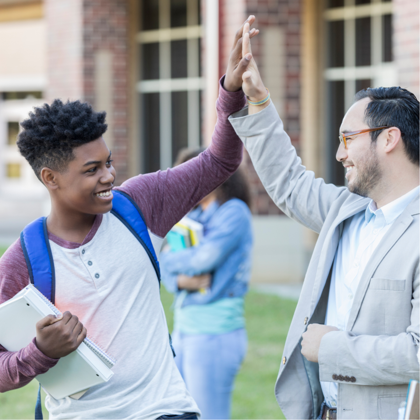 teacher giving student a high five