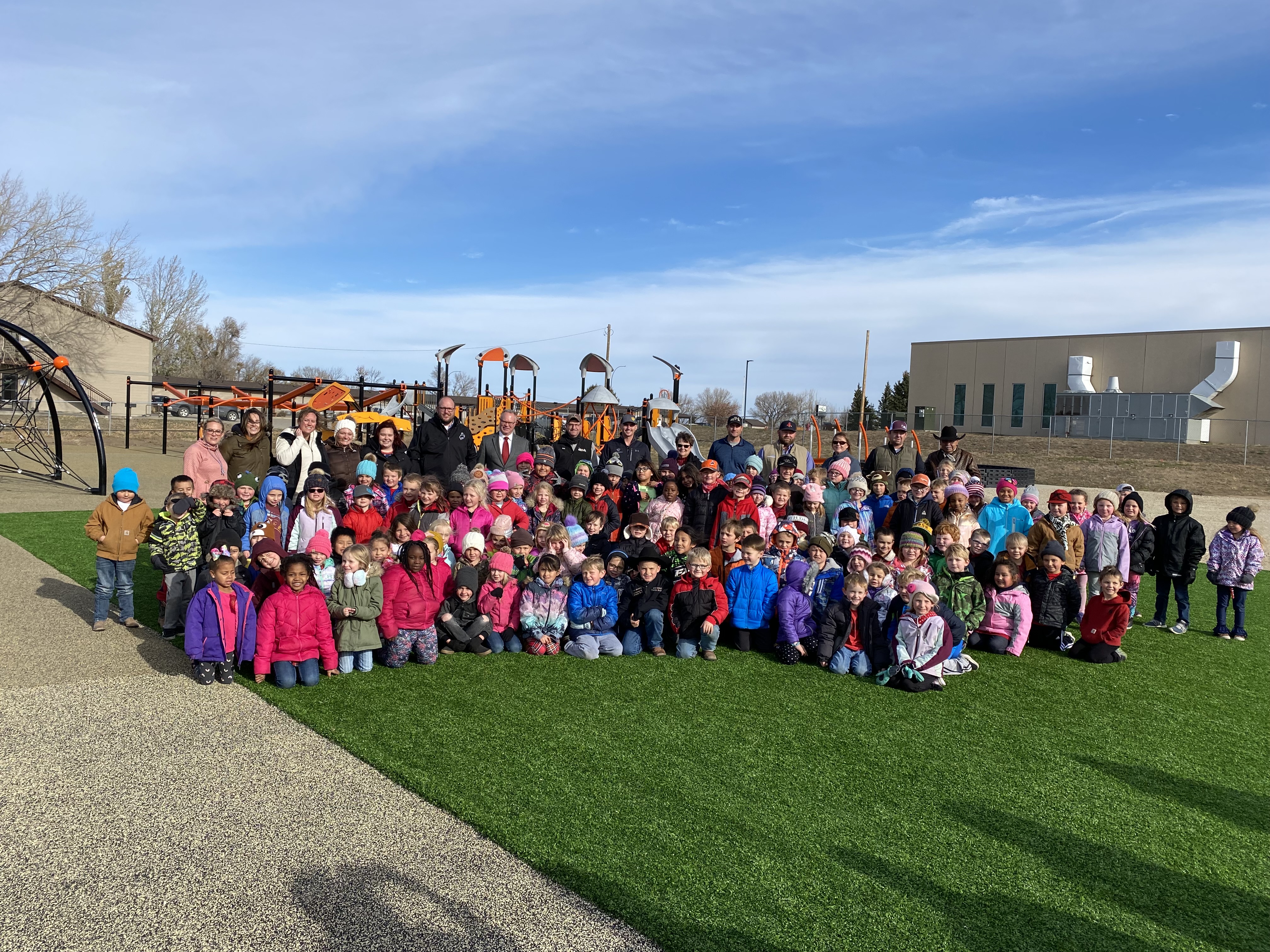 full group picture of students and adults on playground