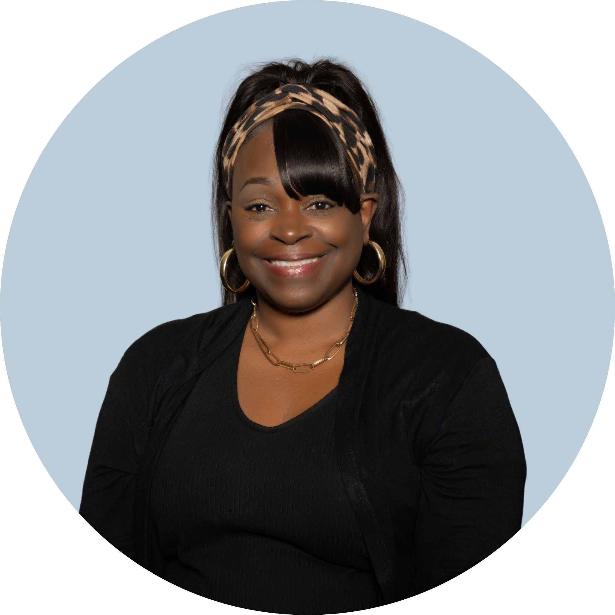 A smiling woman wearing a headband and a black blouse