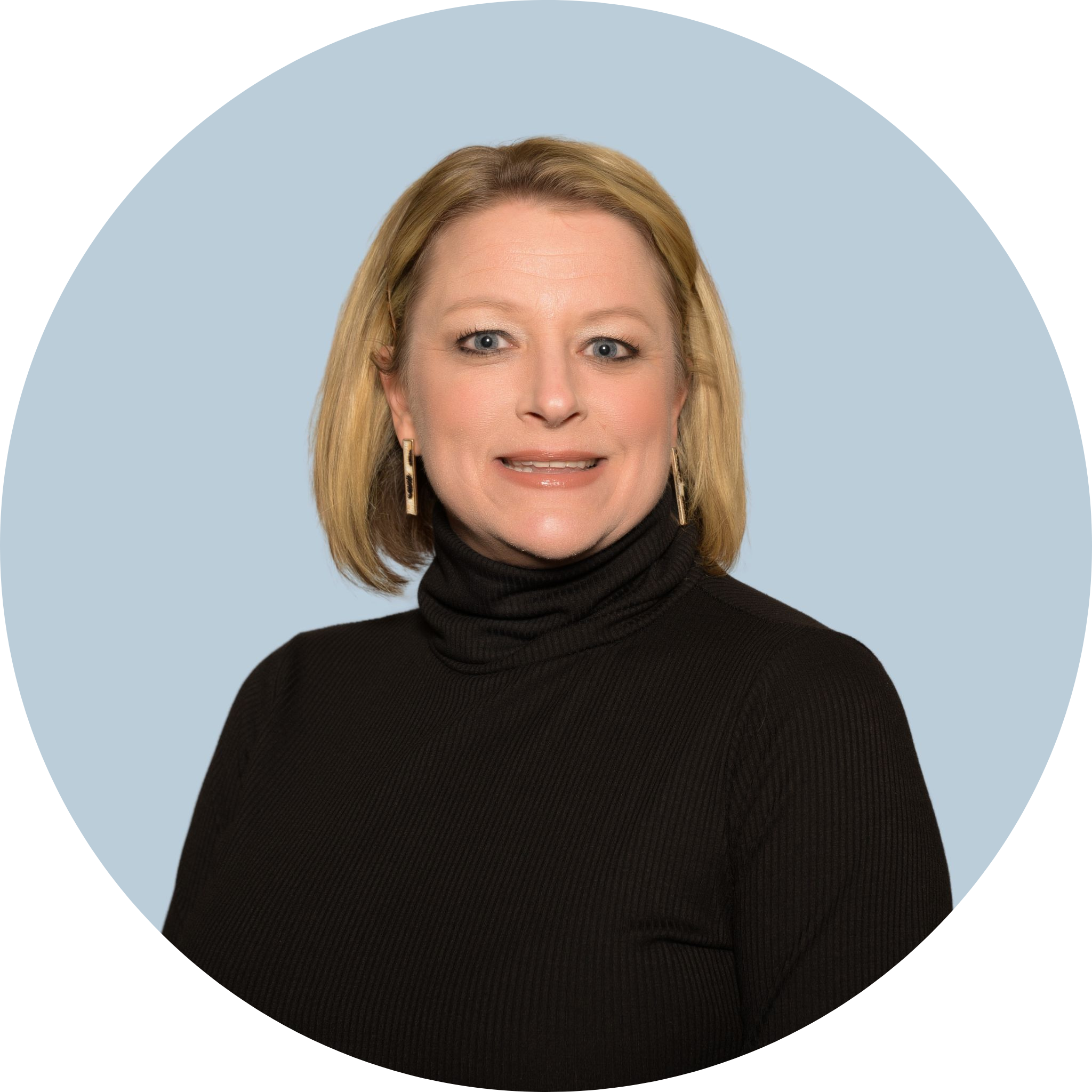 A smiling woman is wearing a black turtleneck