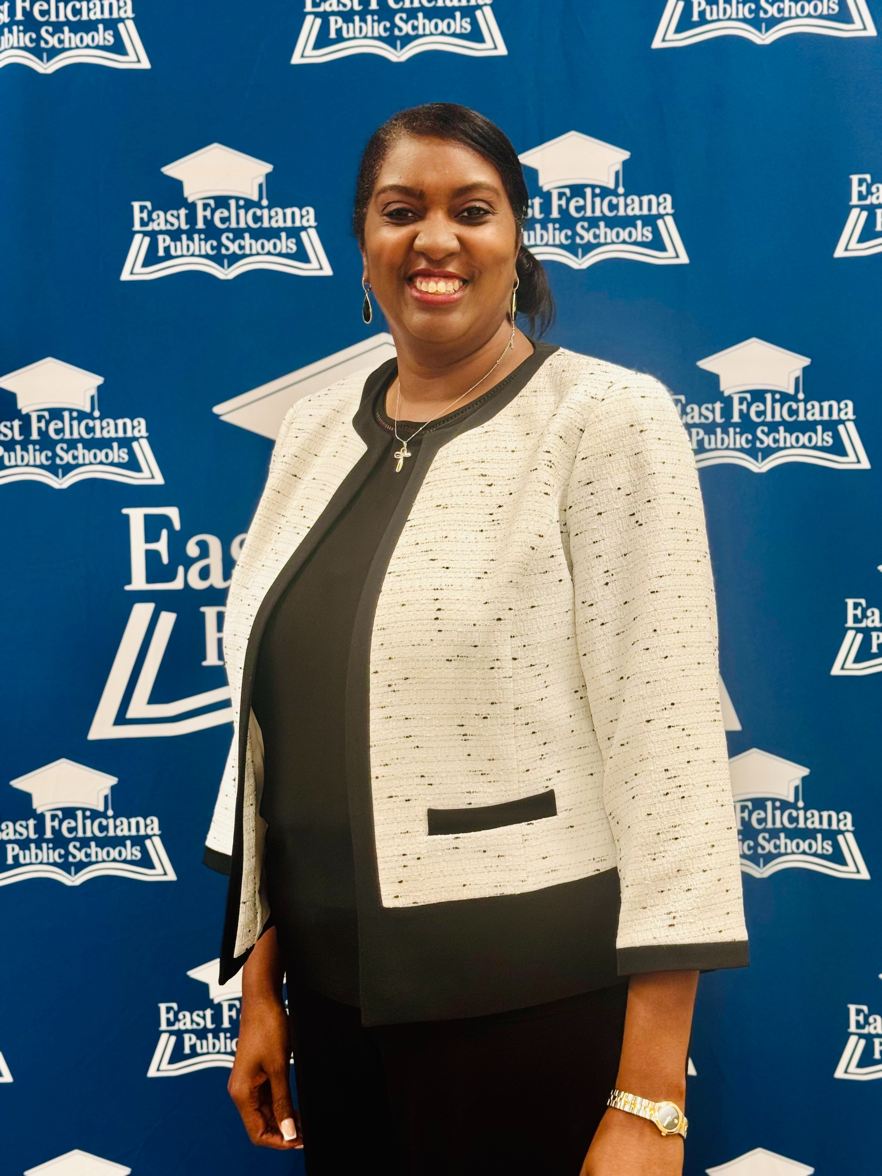 A woman in a suit in front of the EF schools banner.