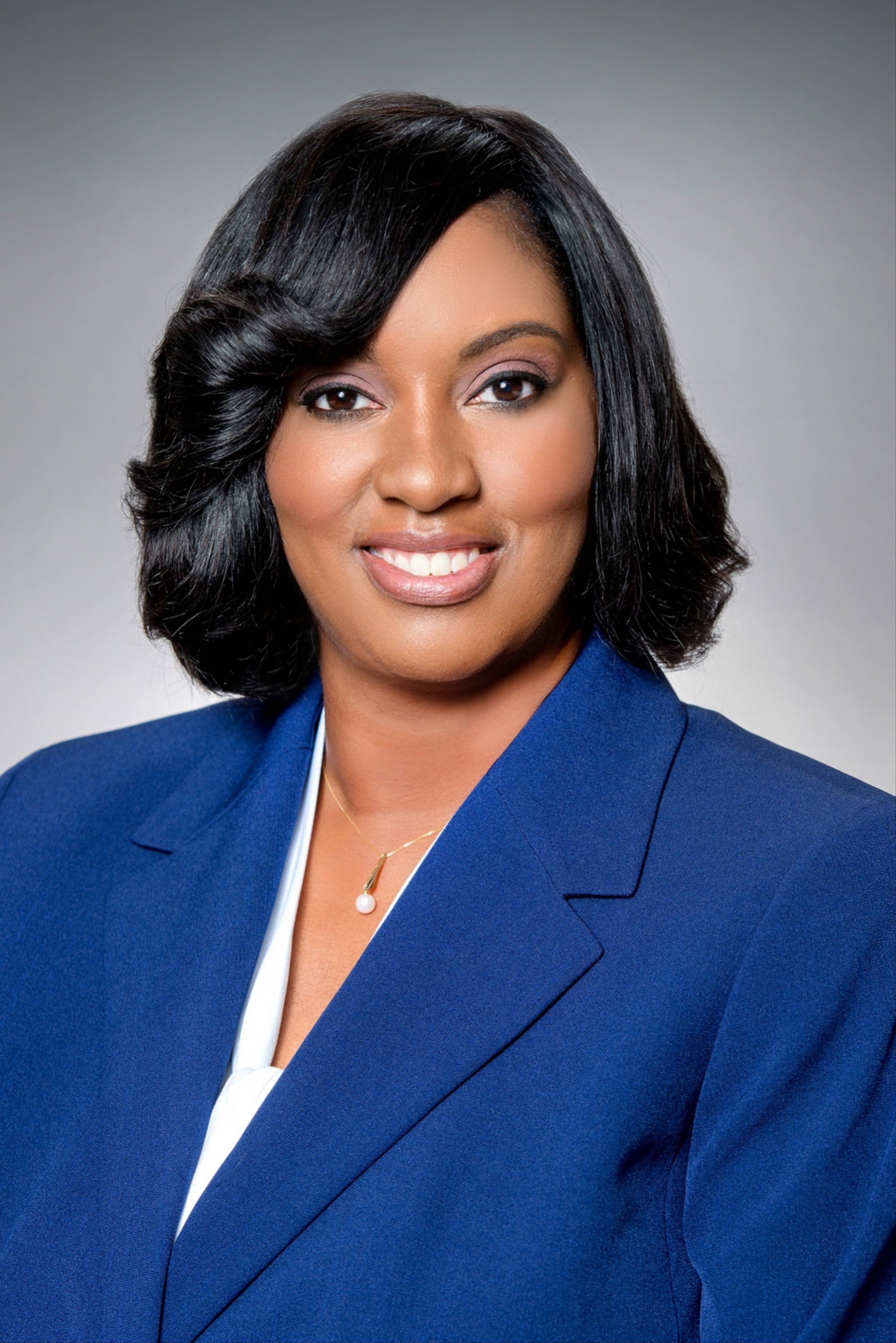 A woman in a suit in front of the EF schools banner.