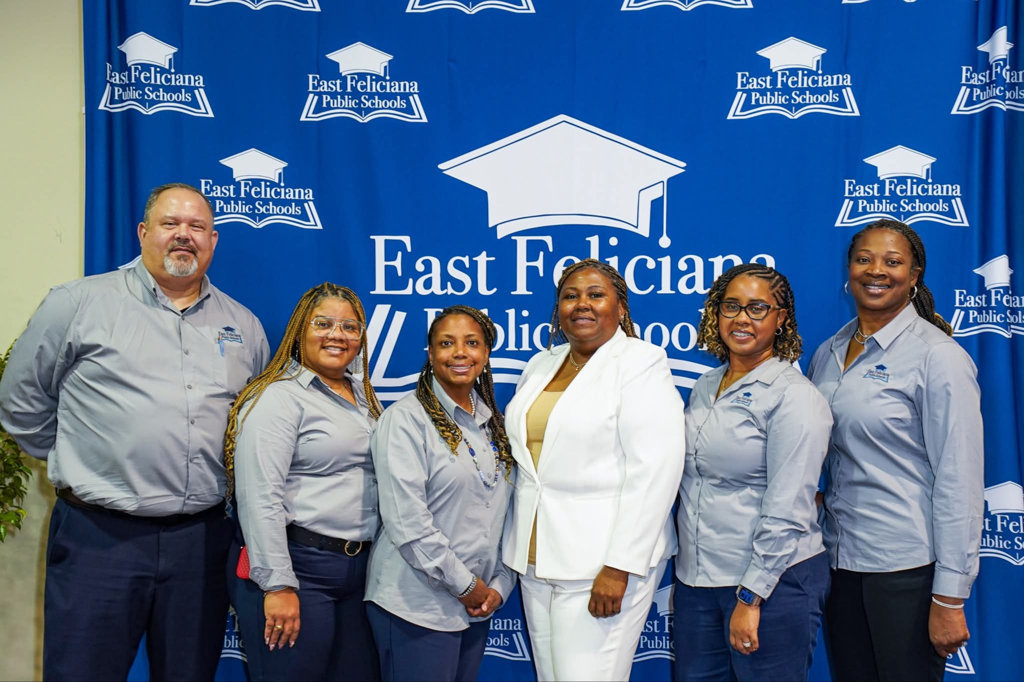 A group of people wearing grey.