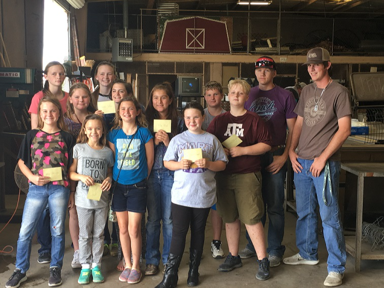 Students posing for the camera in a wood shop