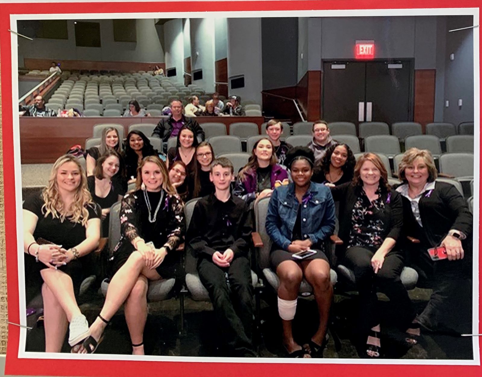 Students sitting and smiling in a theatre