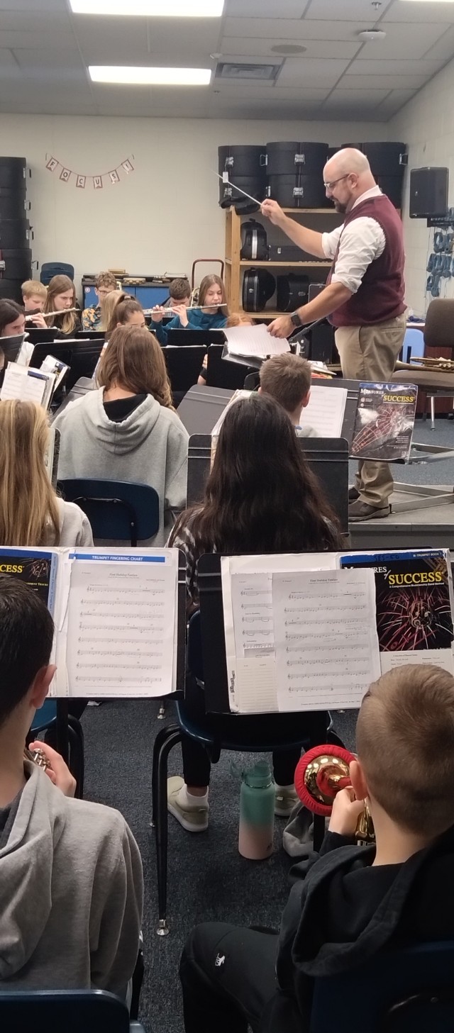 Band students working with guest conductor