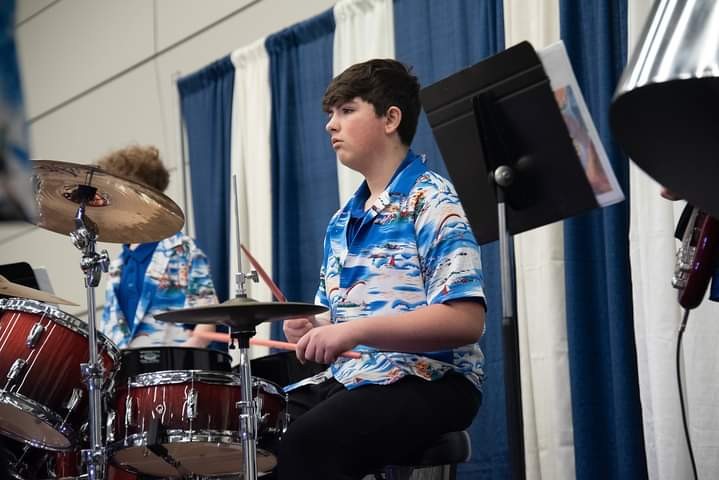 student playing drums