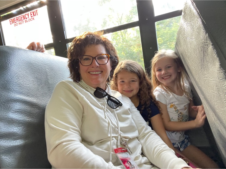 School aide on bus with two young students