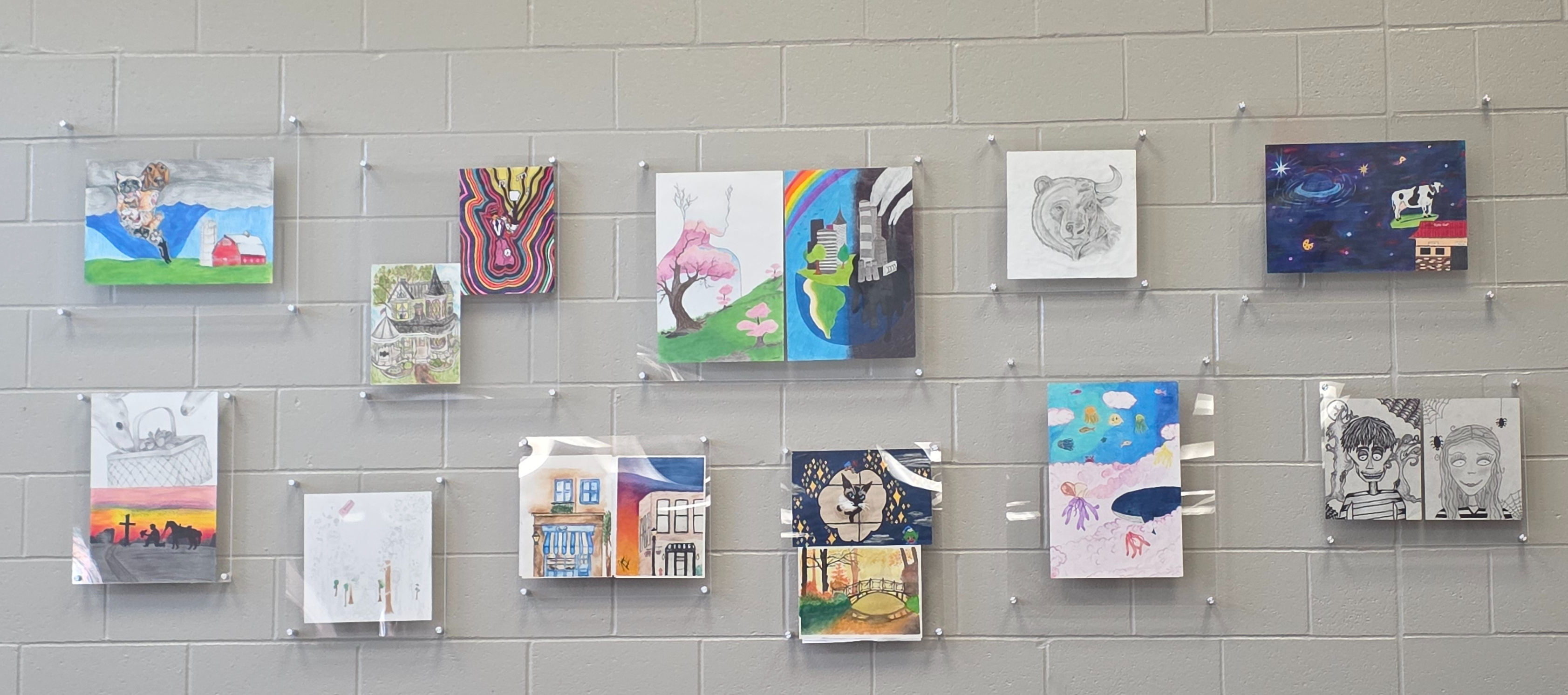 student artwork in frames on the wall