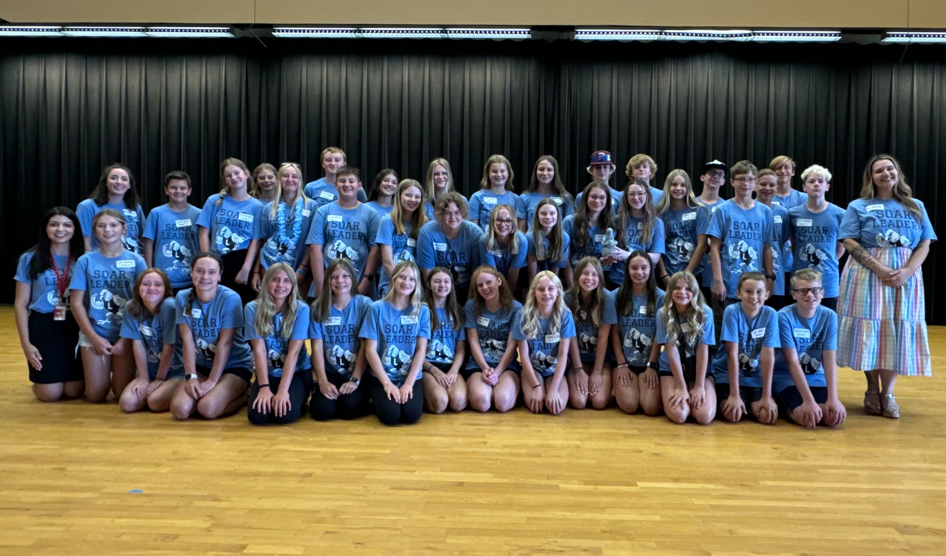 8th grade boys and girls in blue shirts