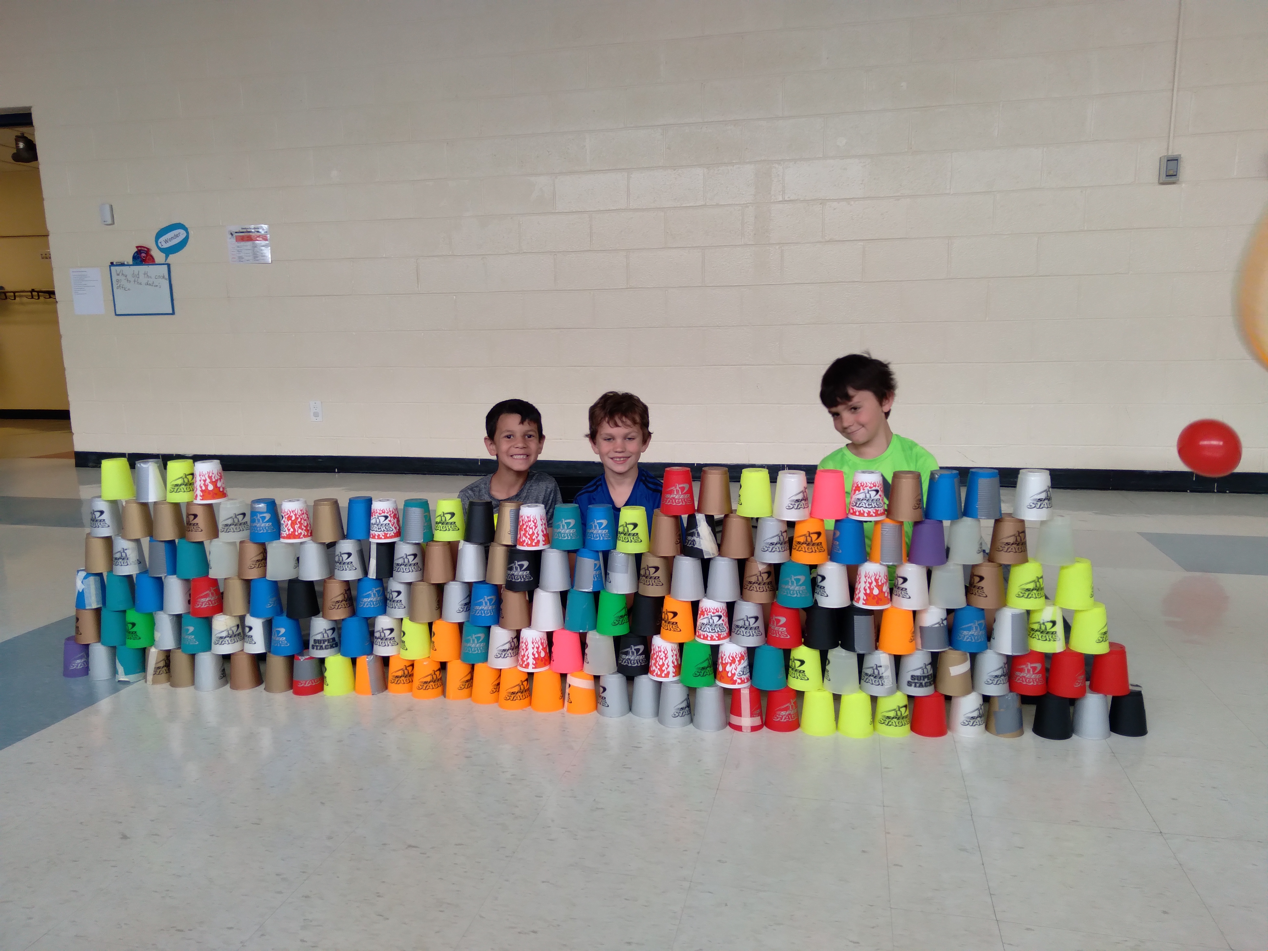 school age children building with cups