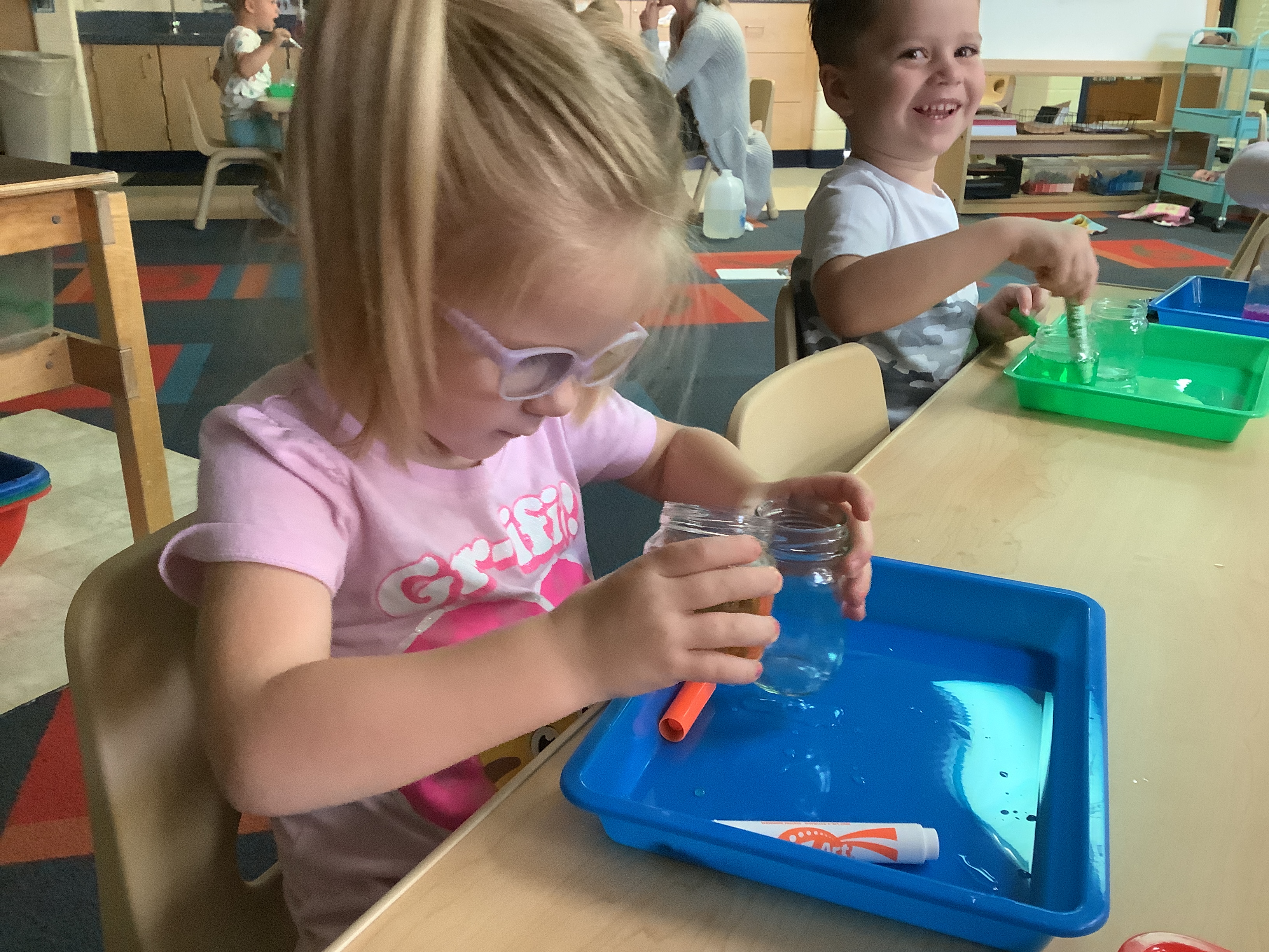 pouring water  back and fourth and mixing colors 