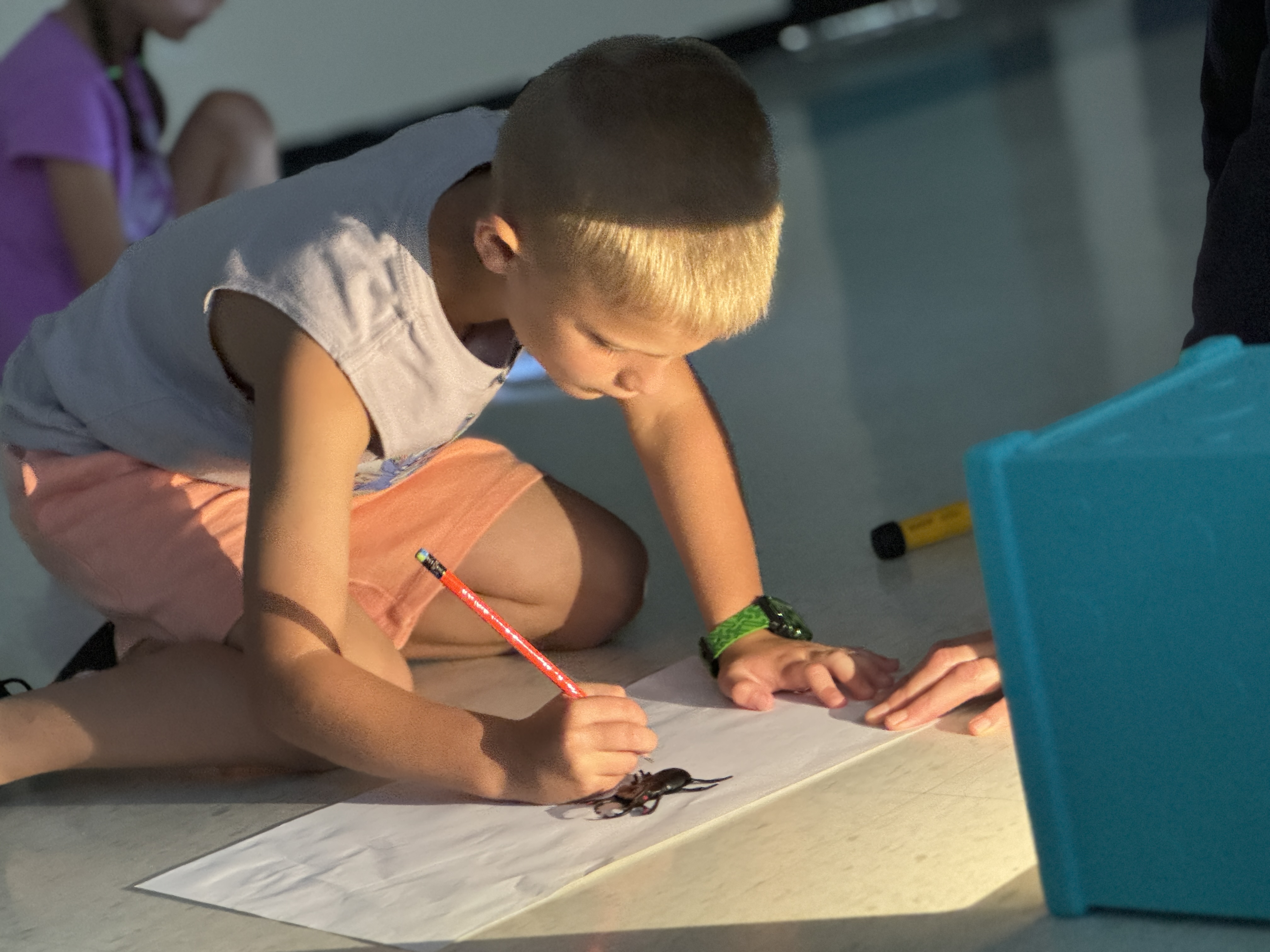 child drawing shadows