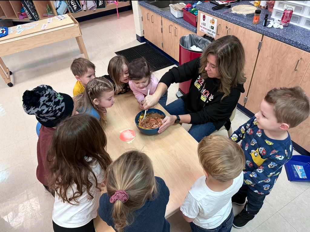 Students with a teacher at a table
