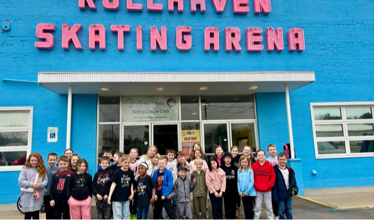 Group of students in front of the entrance to RollHaven Skating Arena
