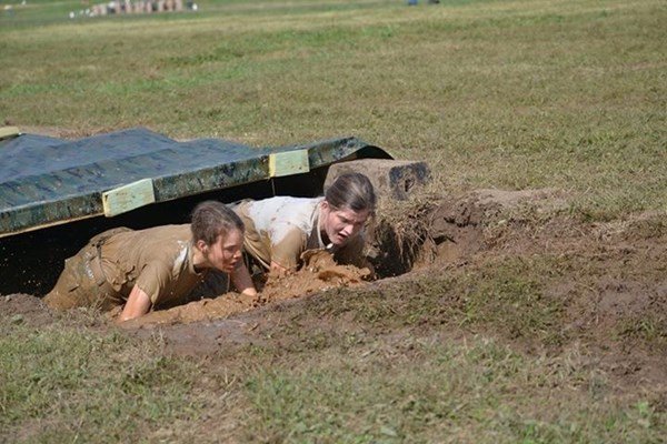 Students crawling through mud