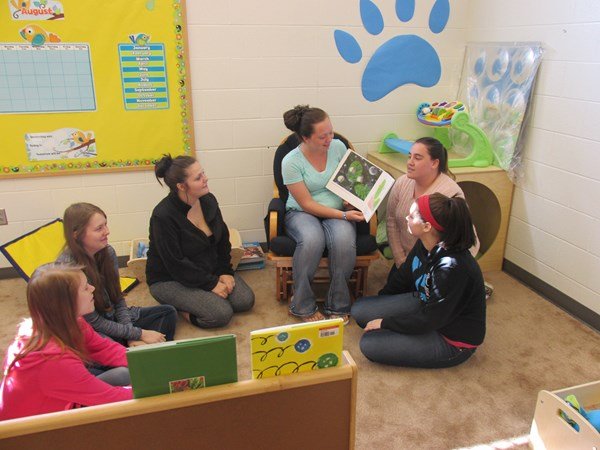 Teacher reading aloud to high school students