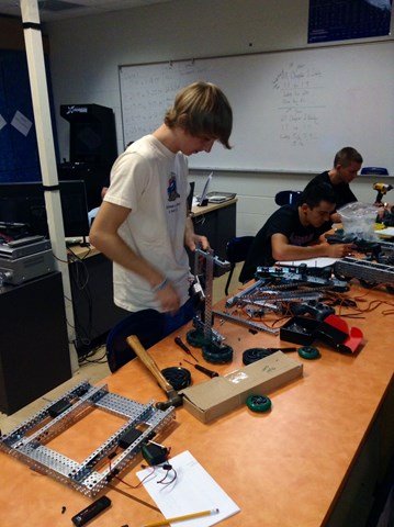 Students working with robotic pieces