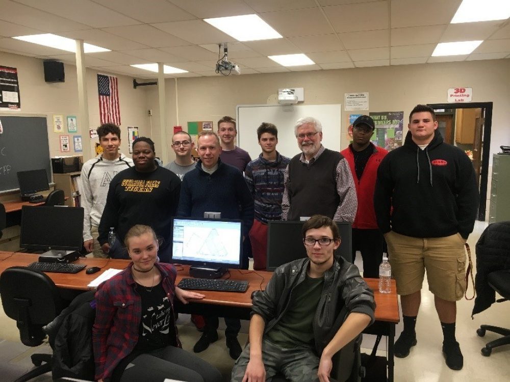 A group picture of students and professor in the classroom