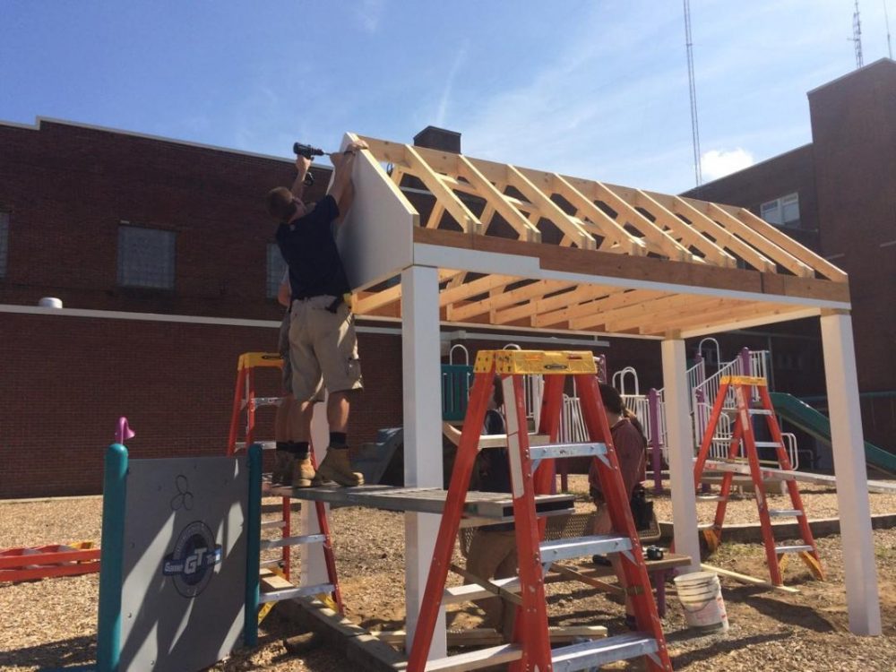 Construction students working on a pavilion