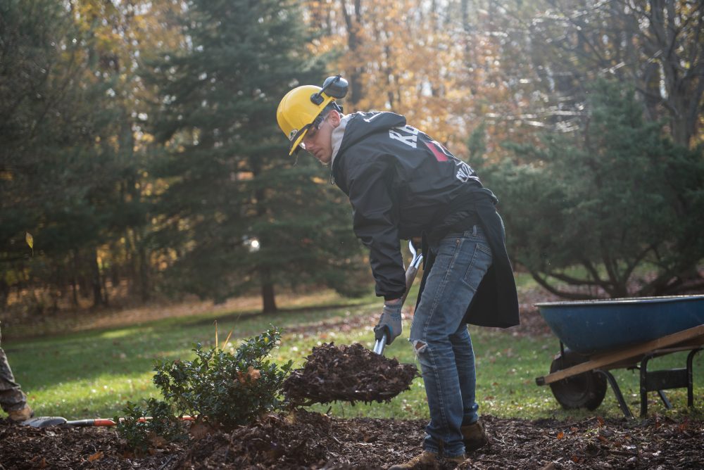 Student shoveling dirt