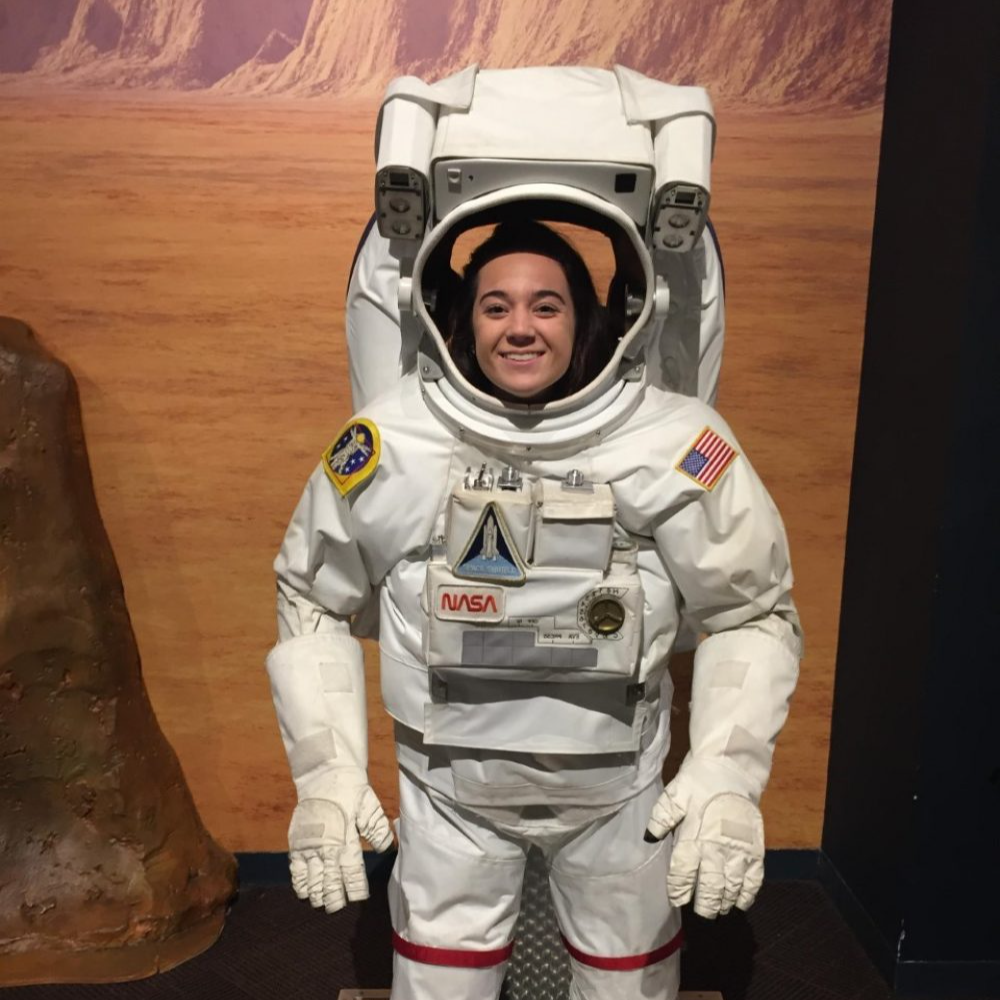 Student posing for a picture in an astronaut suitdisplay