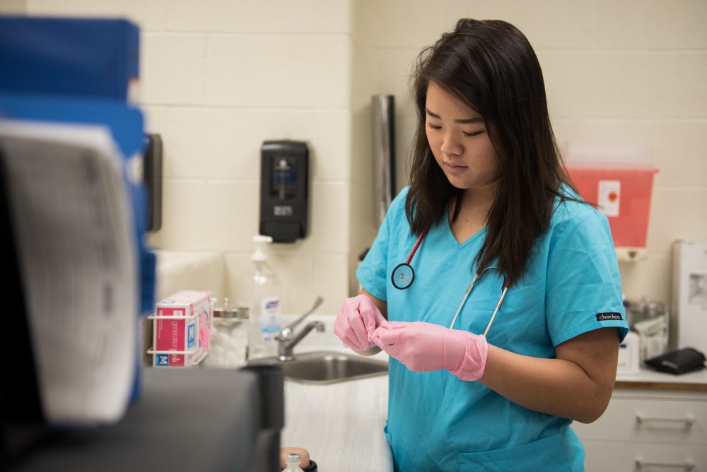 Student practicing filling a syringe for a shot