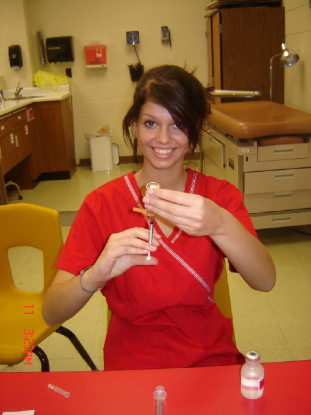 Student practicing filling a syringe for a shot