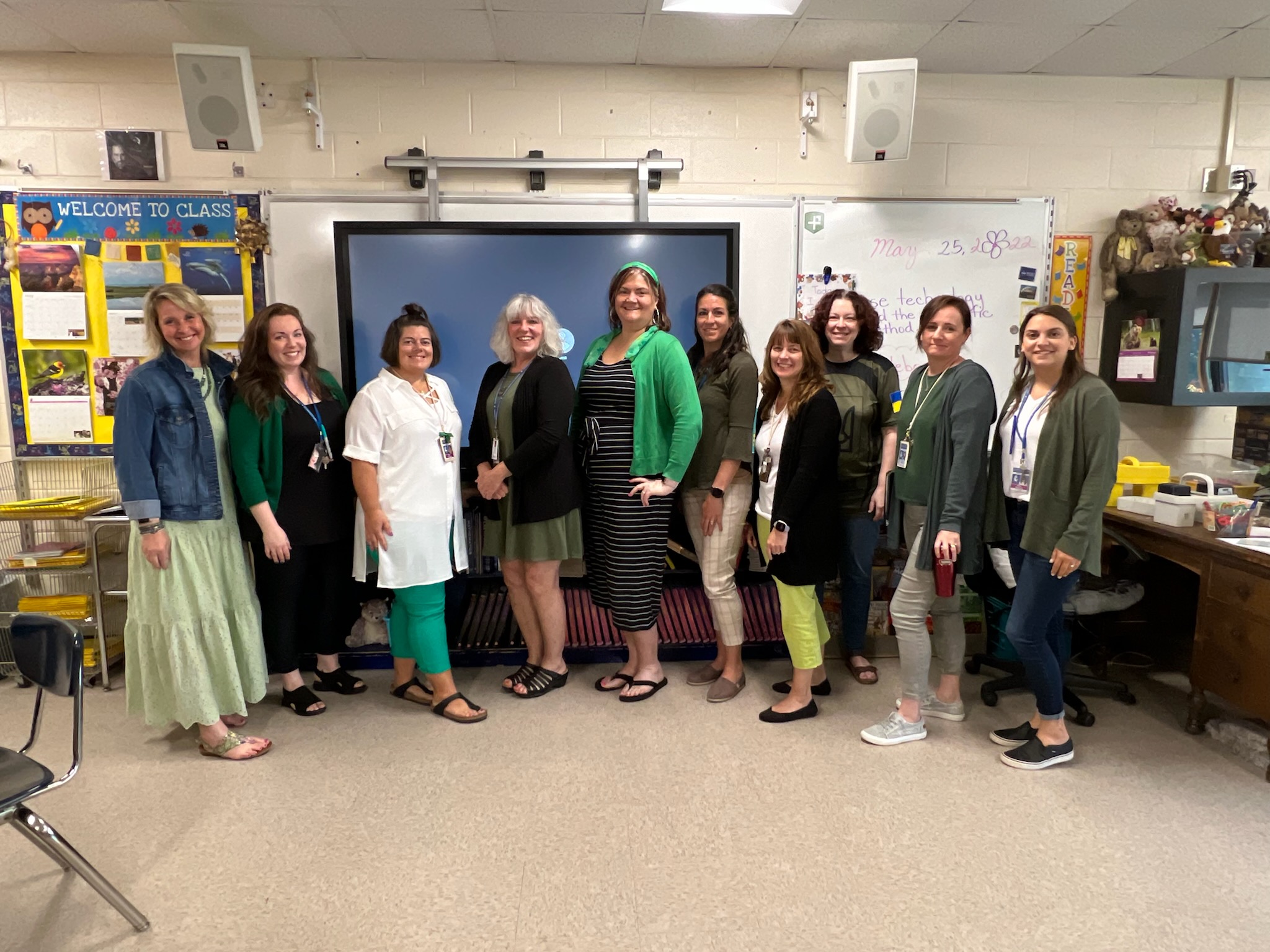 middle school staff members wearing green for Mental Health month