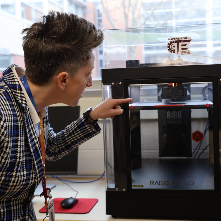 Our secondary curriculm director, Bonnie Fineman watches student work being printed on one of WHS' CTE's 3D printers. 
