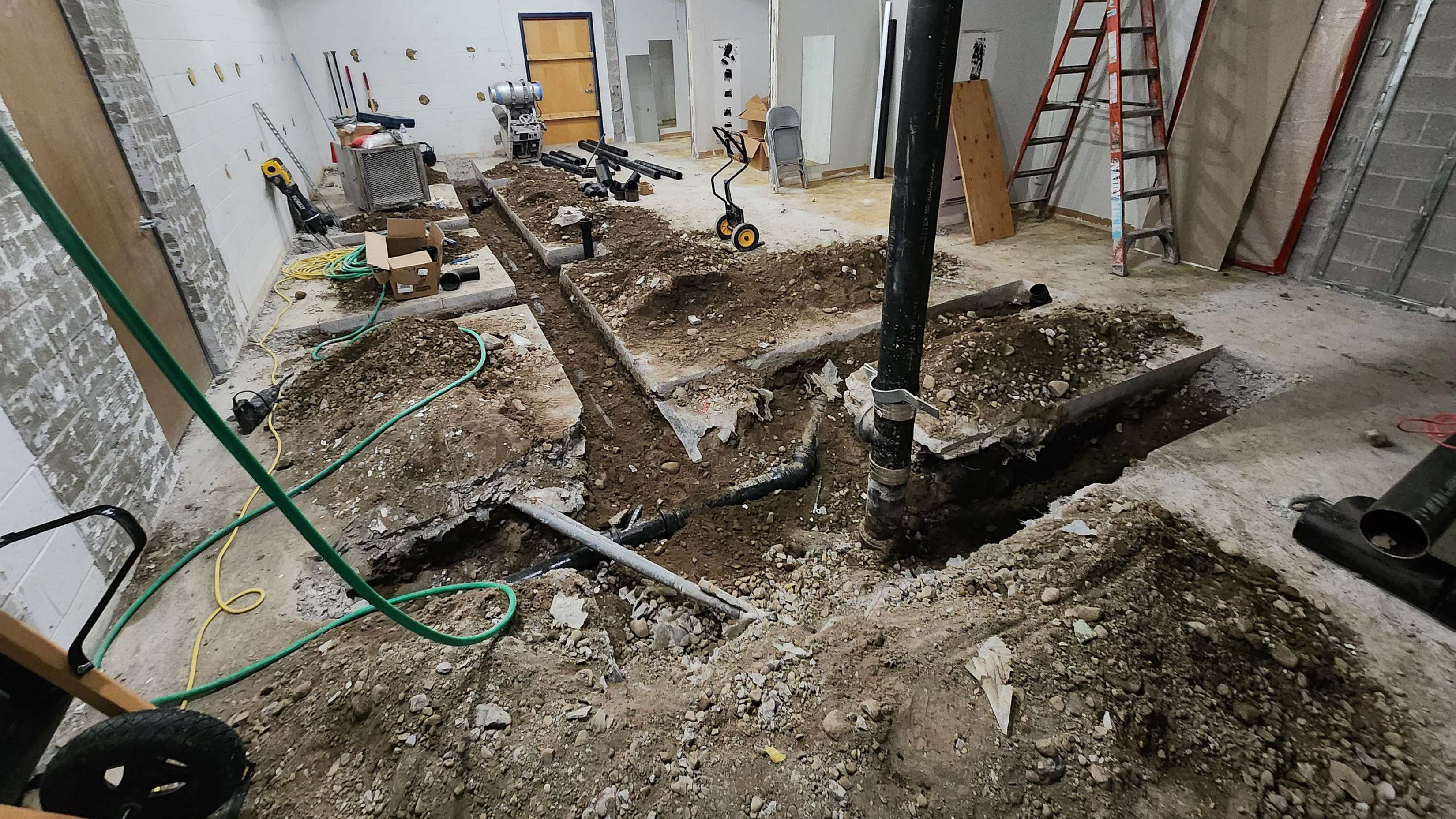 Highschool Auditorium Toilet Room Under-Slab Plumbing