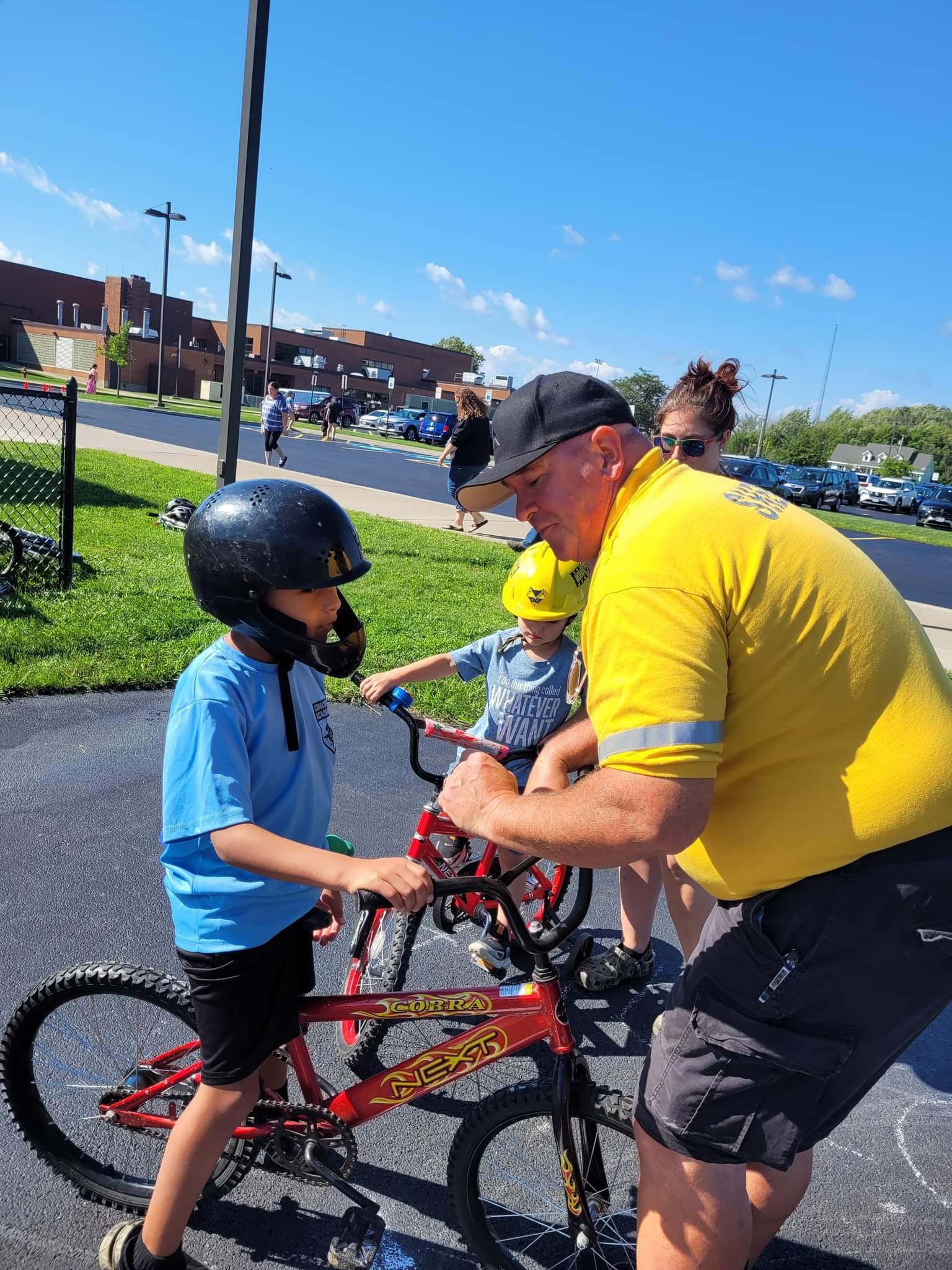 Deputy Johnson assisting student on bike