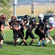 football play in action. CPS players in black uniforms