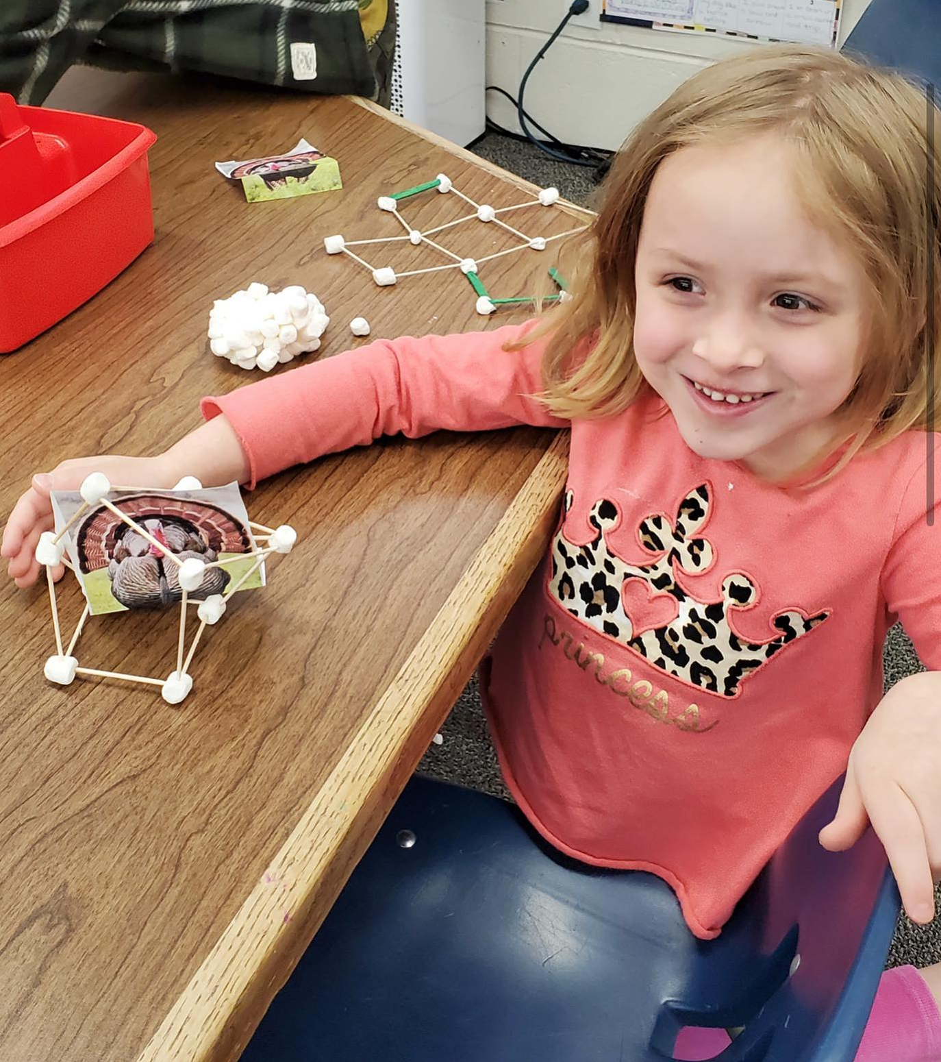 girl building a turkey out of connecting blocks