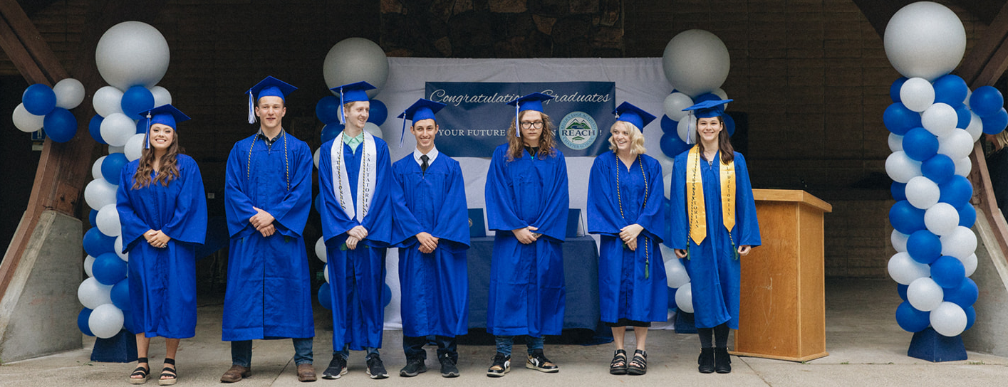 graduates line up with diplomas