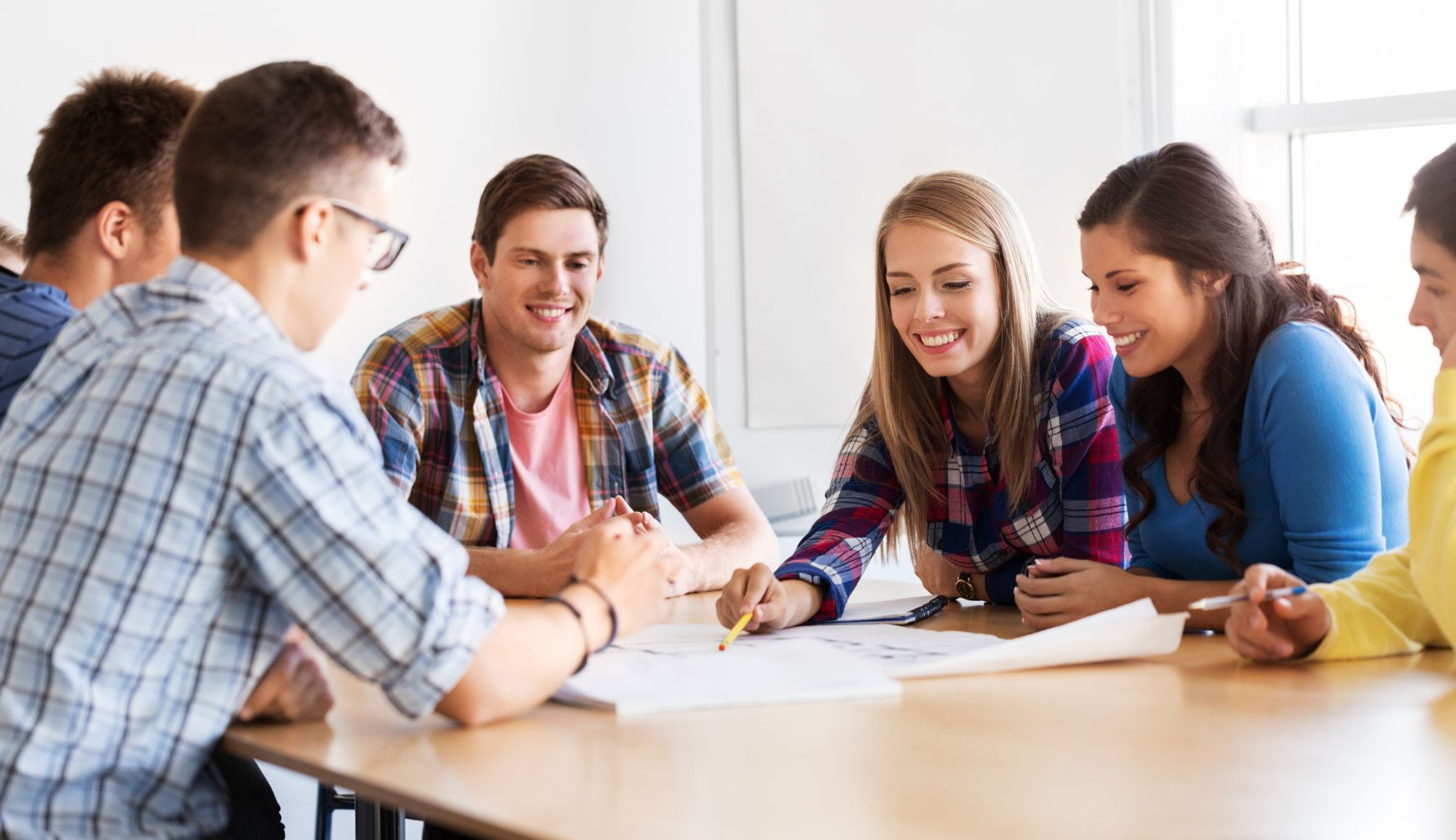 High school students sitting at a table and working together