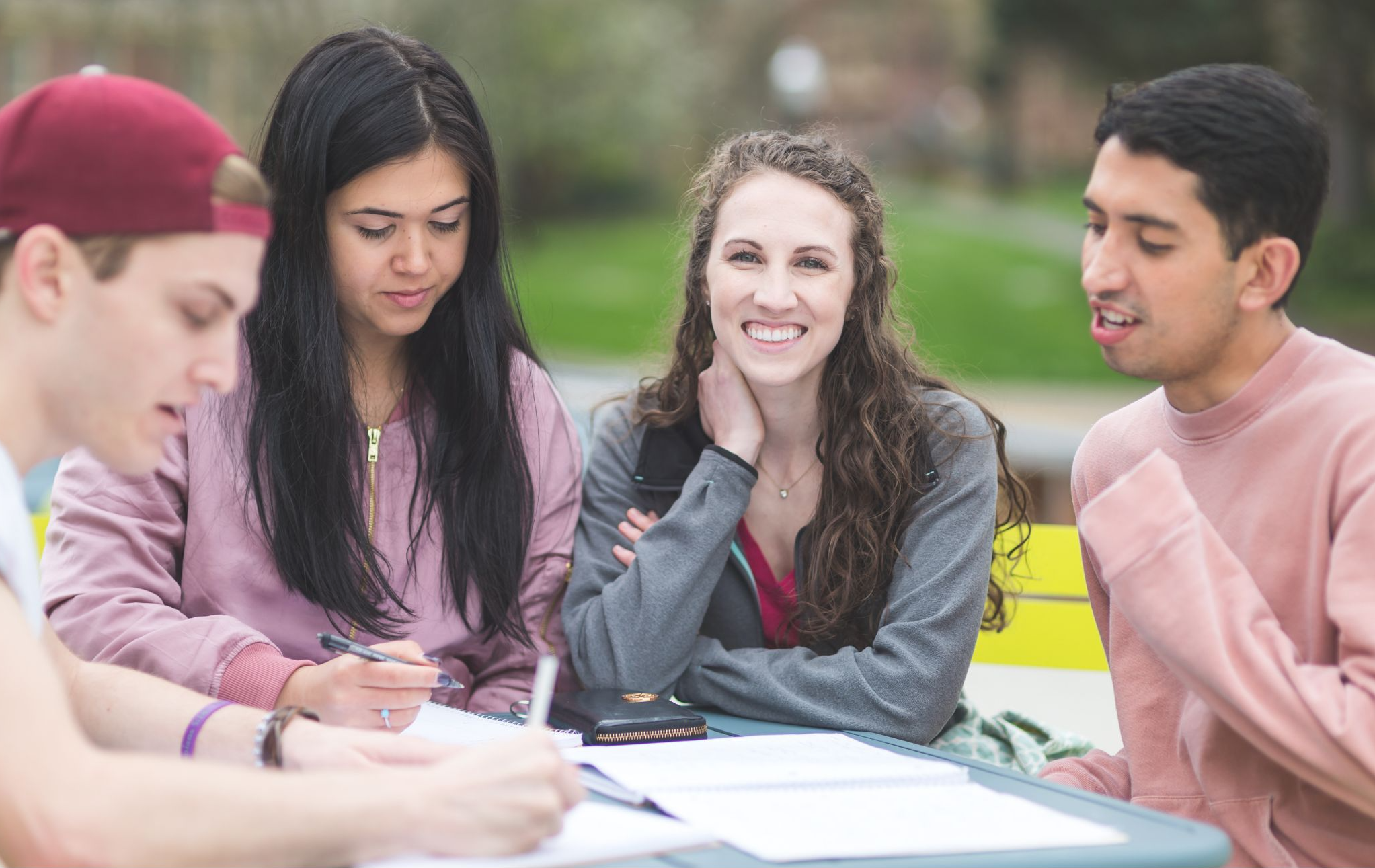 students at table outside studying together