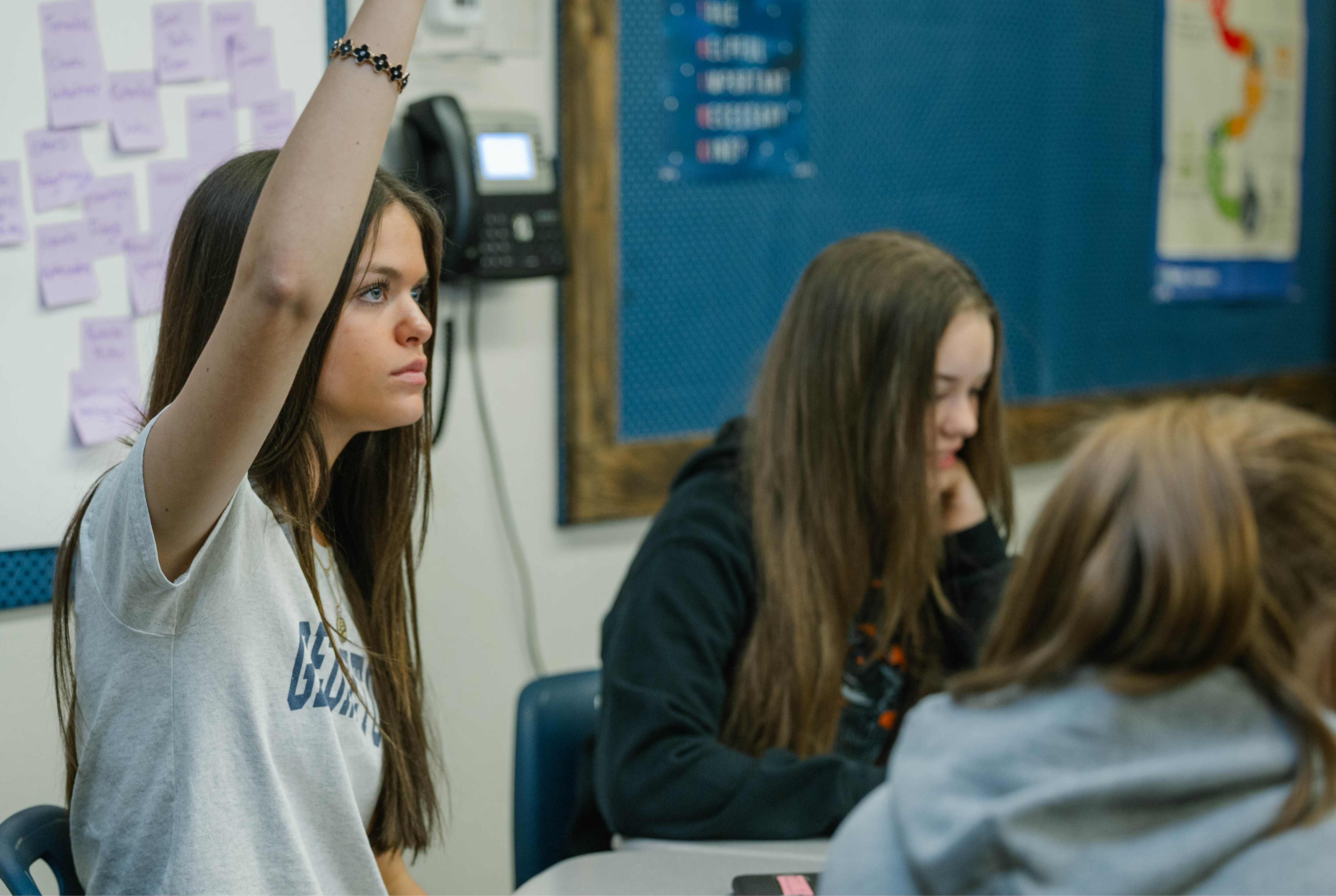 Student raising hand in class