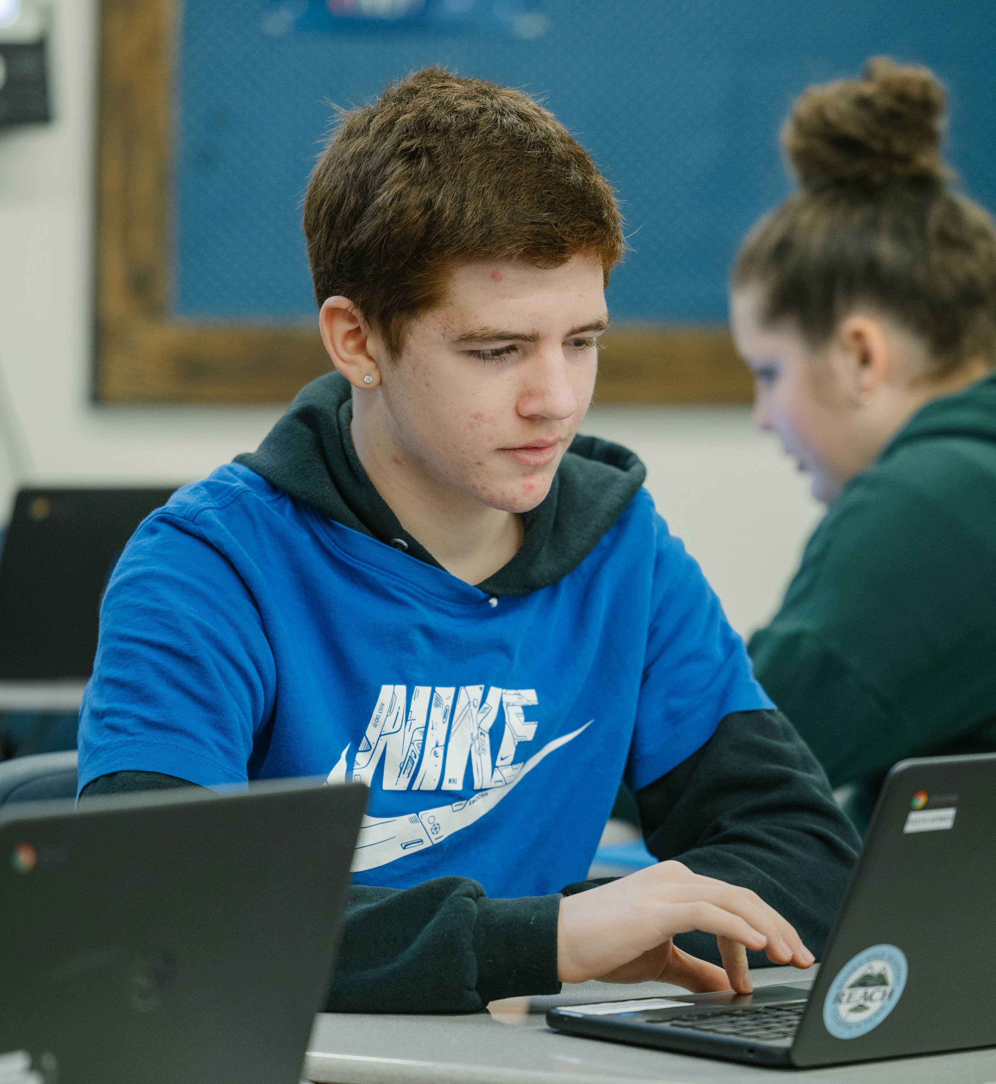 student at desk working on computer