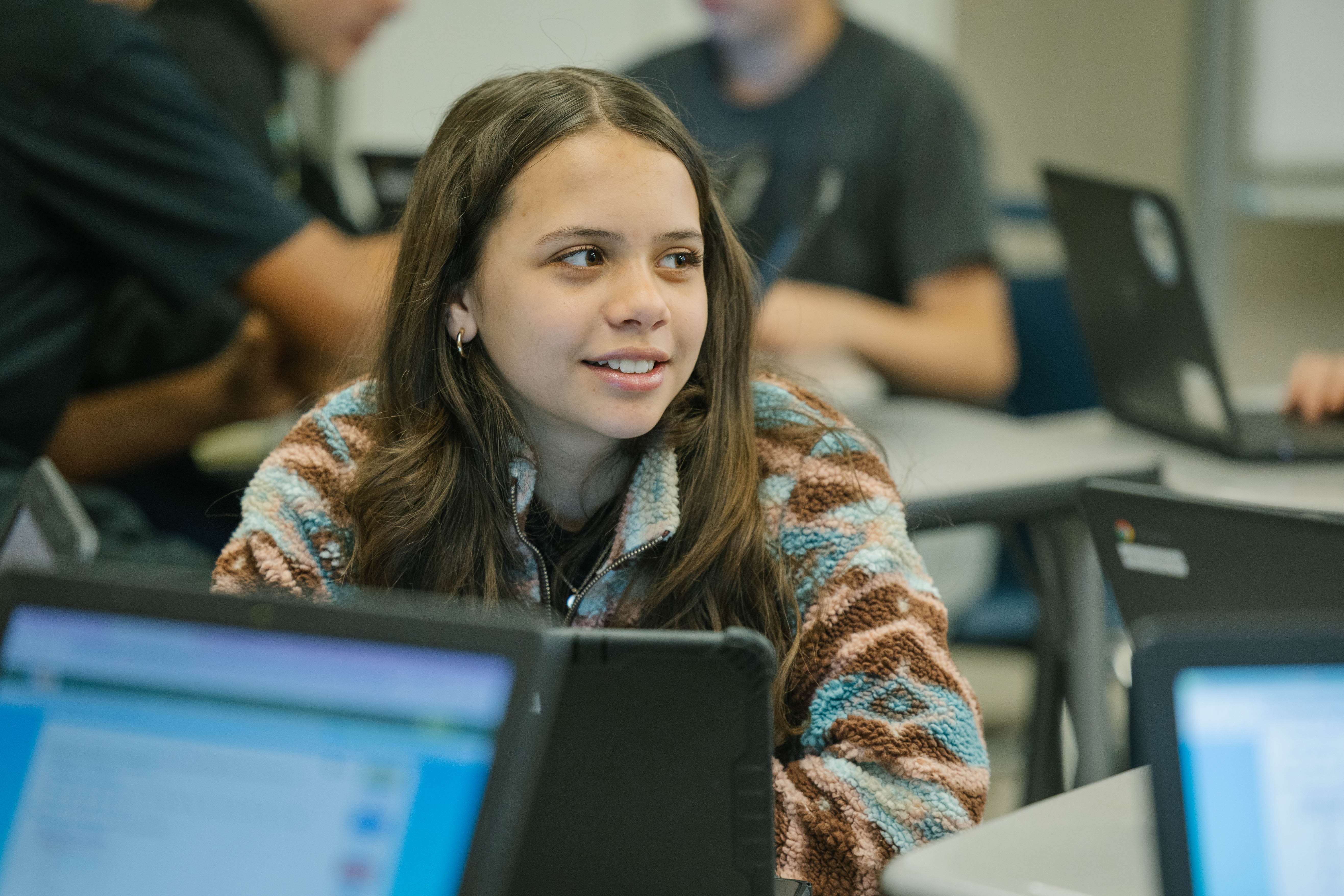 Student at desk looking away