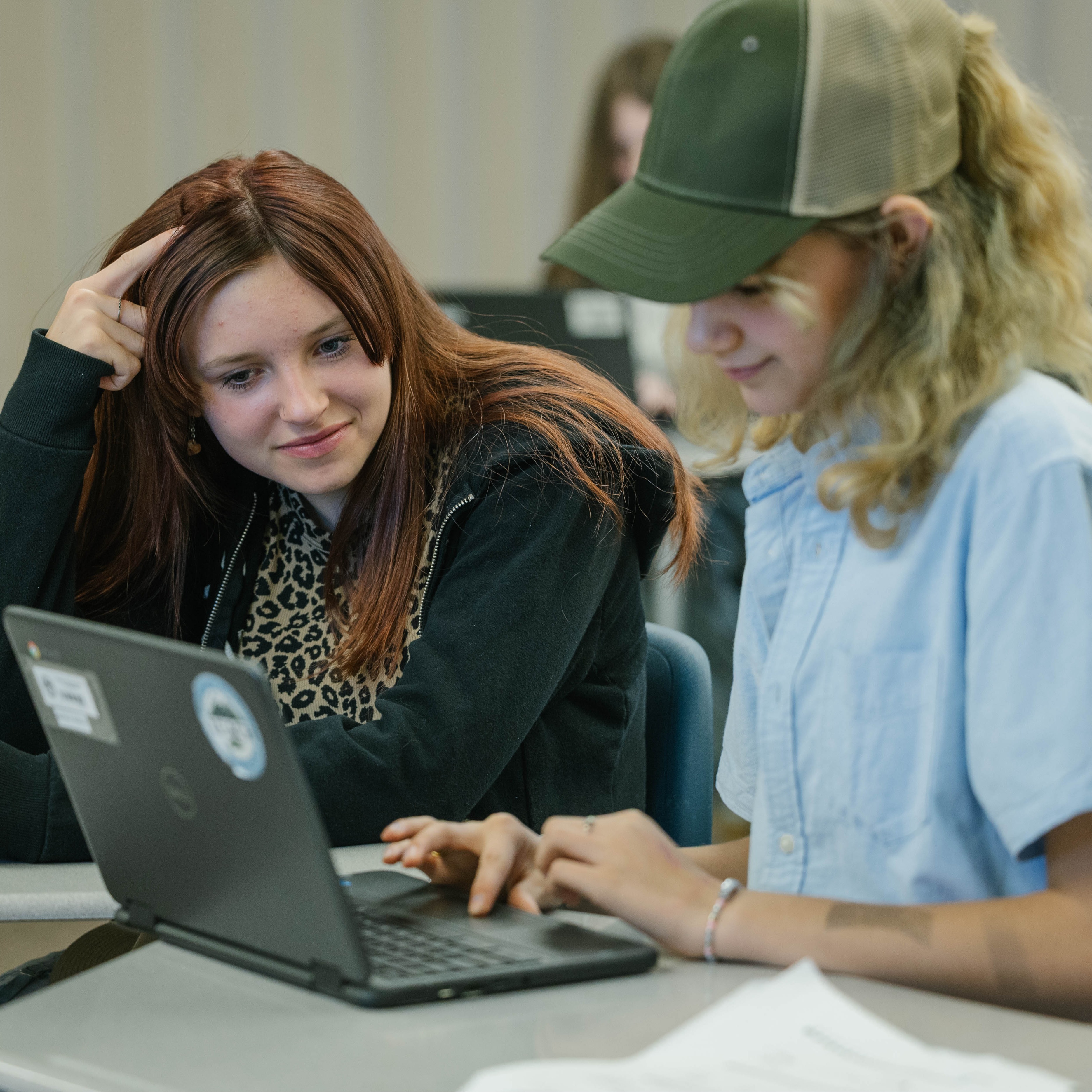 Two students working together at computer