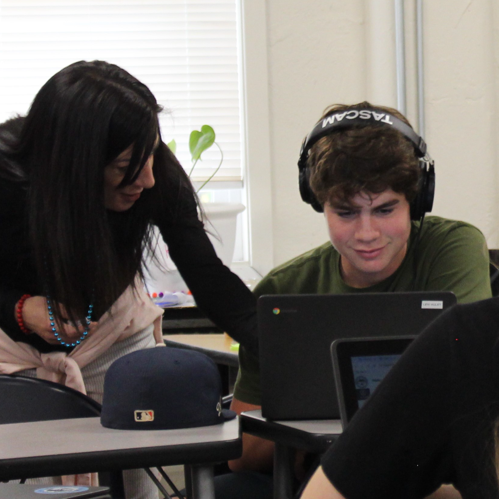 Teacher helping student